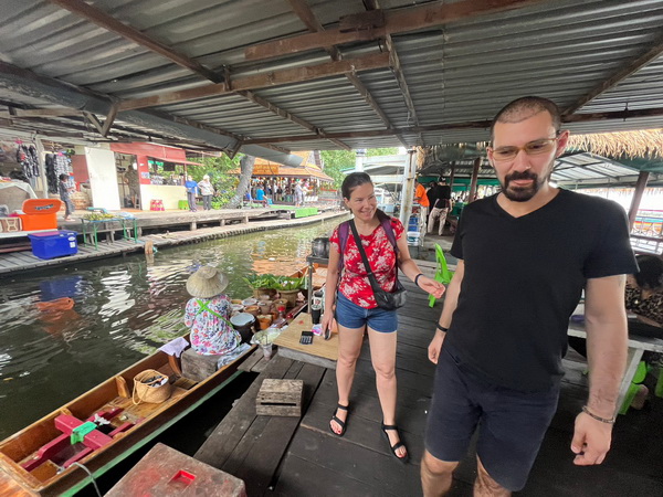 Exploring boats and vendors at Khlong Lat Mayom floating market