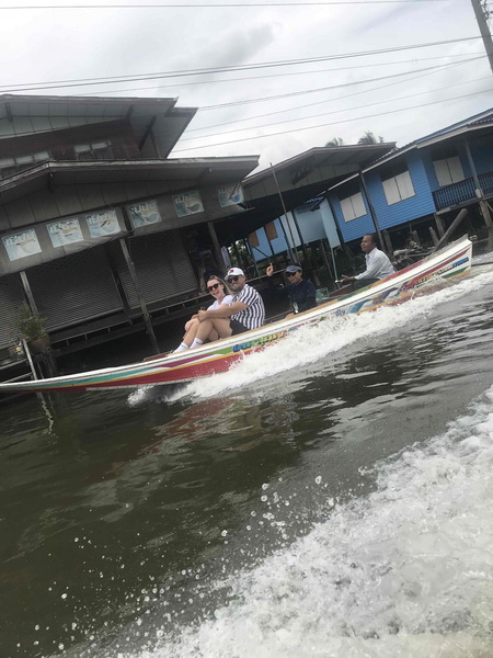 Rocket boat speeding through narrow Bangkok canals past stilted houses