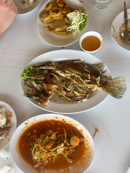 Delicious Thai seafood lunch spread with grilled fish, prawns, and spicy sauces on the Gulf tour