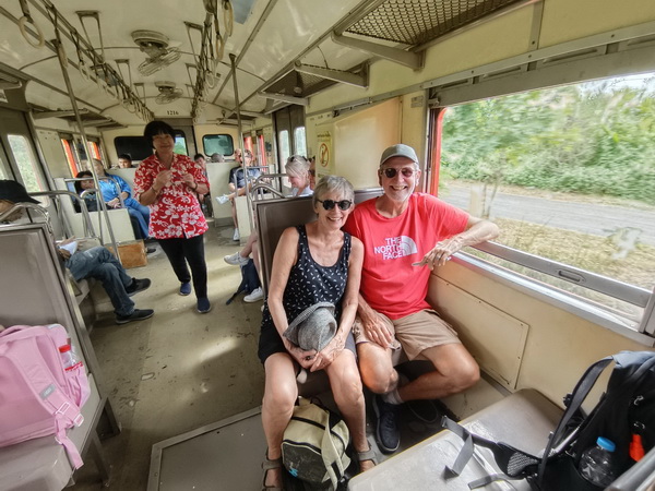 Happy tour guests riding the local train between Maeklong and Mahachai