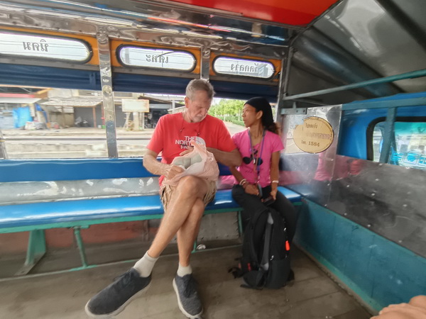 Tour guests riding in a local songtaew shared taxi during the Crazy Markets tour