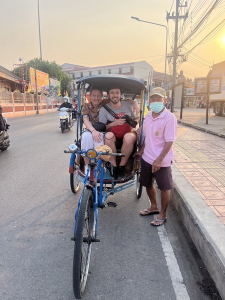 Traditional sam lor tricycle taxi with guests and driver in Mahachai