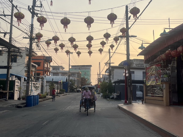 Early morning sam lor ride through decorated streets with hanging lanterns