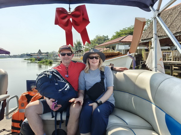 Couple enjoying a relaxing boat ride on the Tha Chin river during the Nakhon Pathom tour