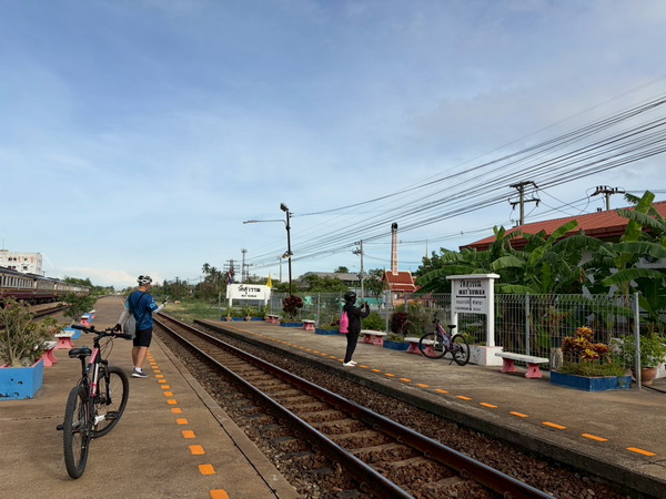Cyclists waiting on the platform at Nakhon Pathom train station