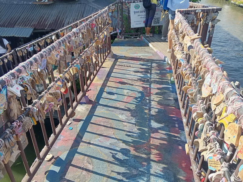 The colourful Bridge of Keys covered in padlocks at the canal-side artist village