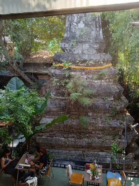 Ancient chedi surrounded by lush greenery at the canal-side artist village