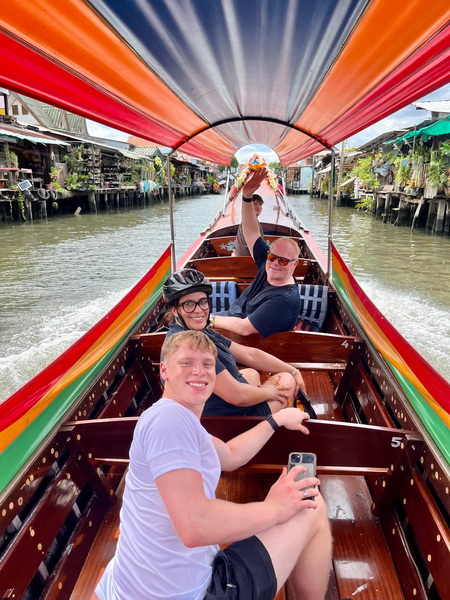 Tour guests enjoying the scenic long-tail boat ride back through Bangkok's canals