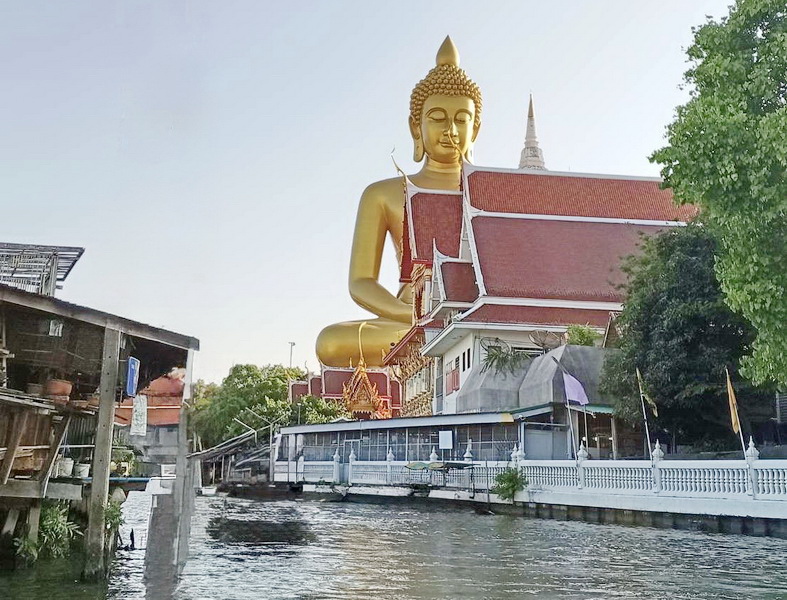 Wat Paknam Phasi Charoen viewed from the river junction with canal houses