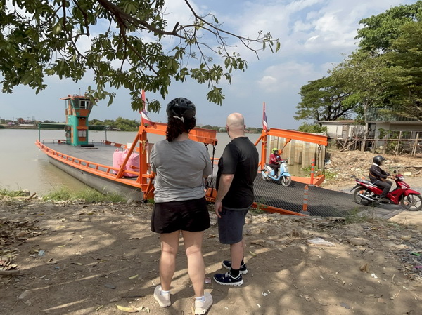Cyclists waiting to board the local ferry to cross the Chao Phraya river