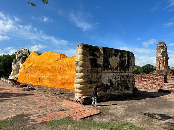 Massive reclining Buddha draped in golden saffron cloth at Wat Lokayasutharam temple in Ayutthaya