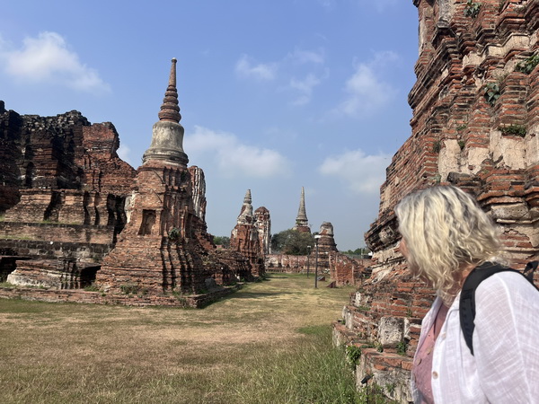 Guest exploring the ancient brick ruins and spires of Ayutthaya's historical temple sites