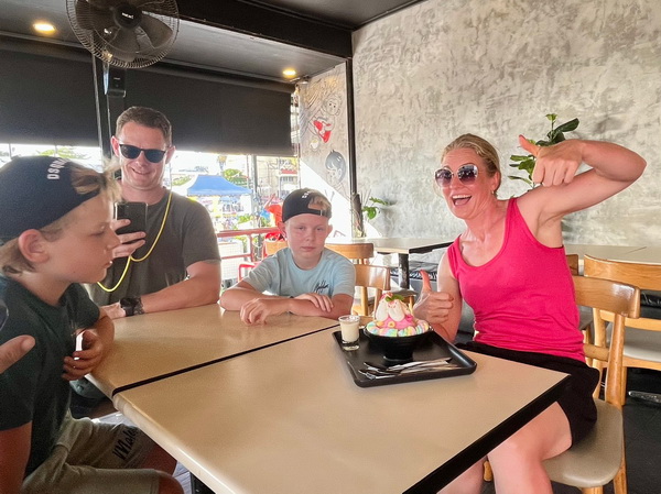Family enjoying a refreshing ice cream break at a local cafe during the tour
