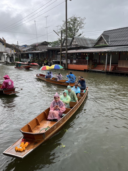 Tourists enjoying a boat trip through the canals at Damnoen Saduak floating market