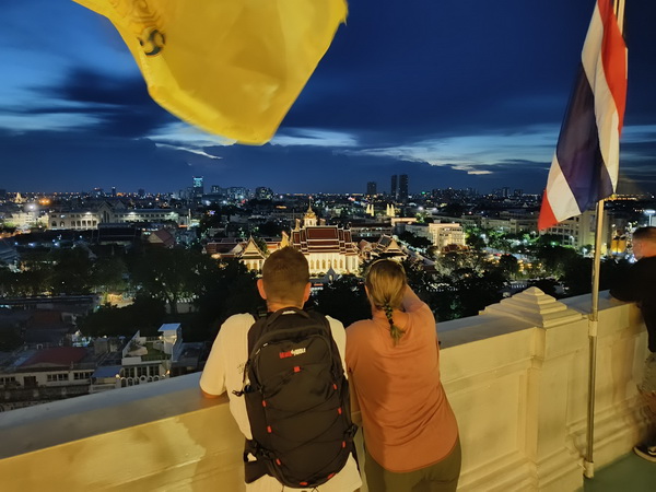 Stunning night view of Bangkok cityscape with illuminated temples and buildings from Golden Mountain after sunset