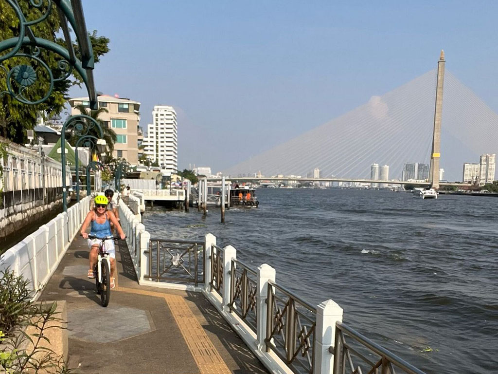 Cyclists exploring hidden Bangkok backstreets and local communities on Behind the Scenes half-day bike tour
