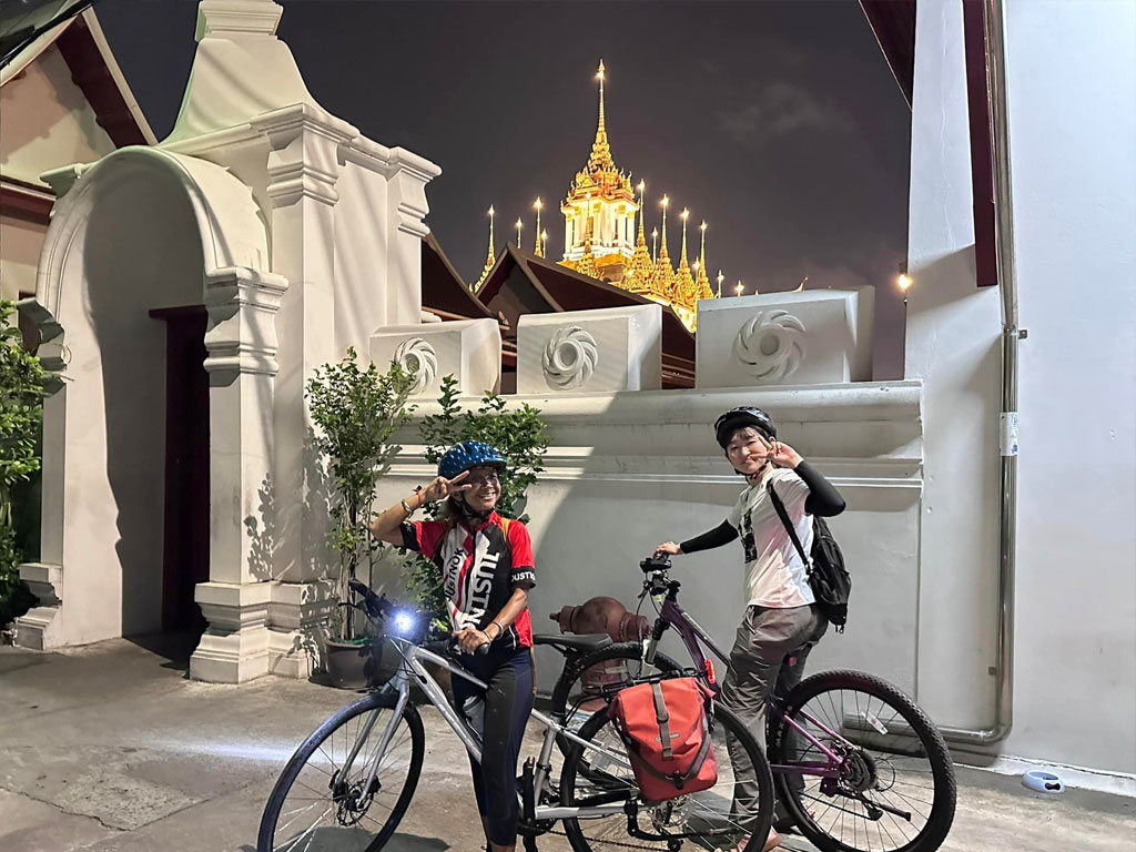 Evening bicycle tour through illuminated Bangkok streets and night markets