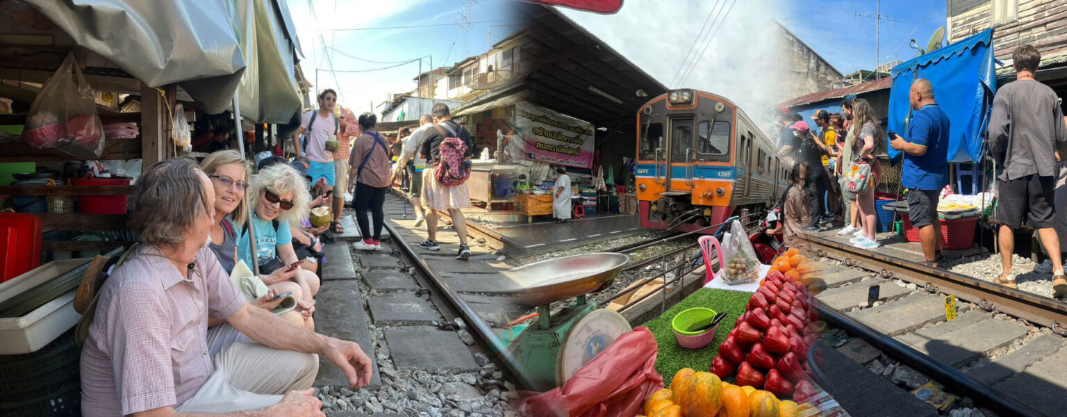 Maeklong Railway Market with train passing through vendor stalls in Bangkok