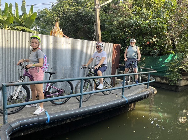 Traditional Bangkok riverside community with wooden houses along canal