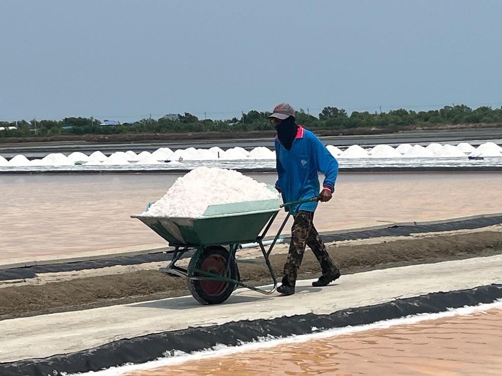Stunning white salt mountains and salt pans at traditional Thai salt farm
